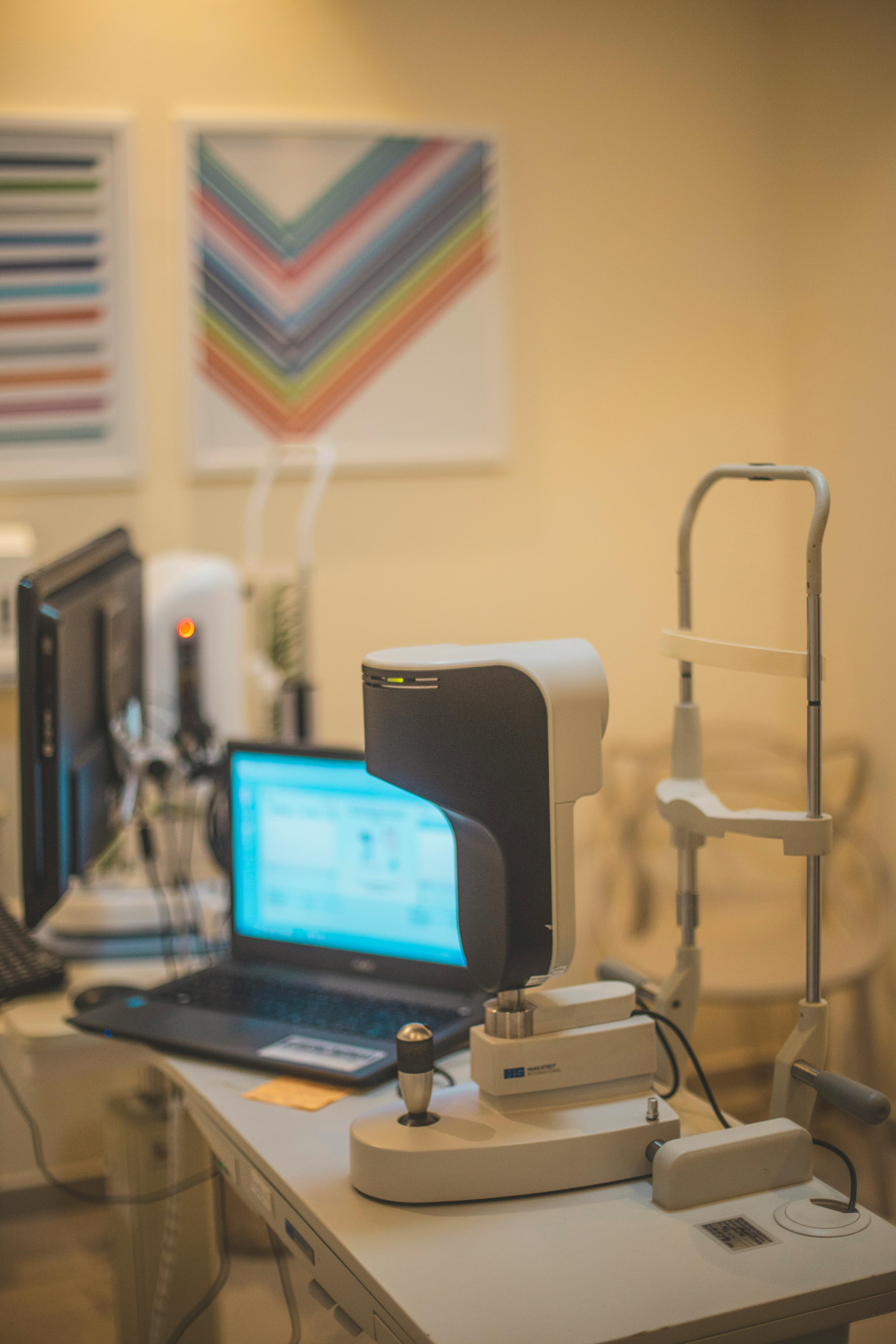 Clinical equipment + laptop on a clean clinic counter
